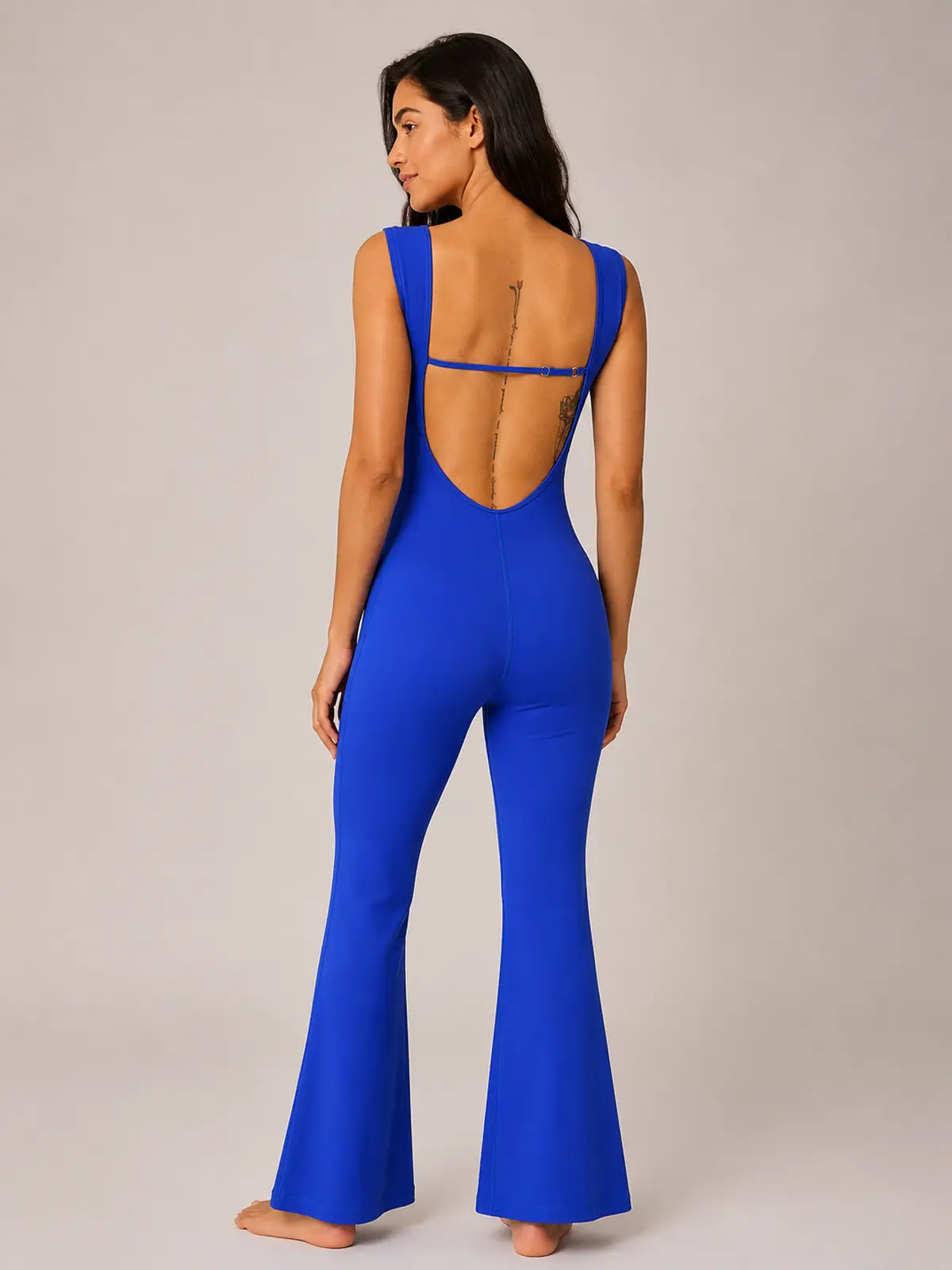 Vesper Arc Sleeveless Flared-Leg Yoga Jumpsuit — royal blue — authoritative variation match