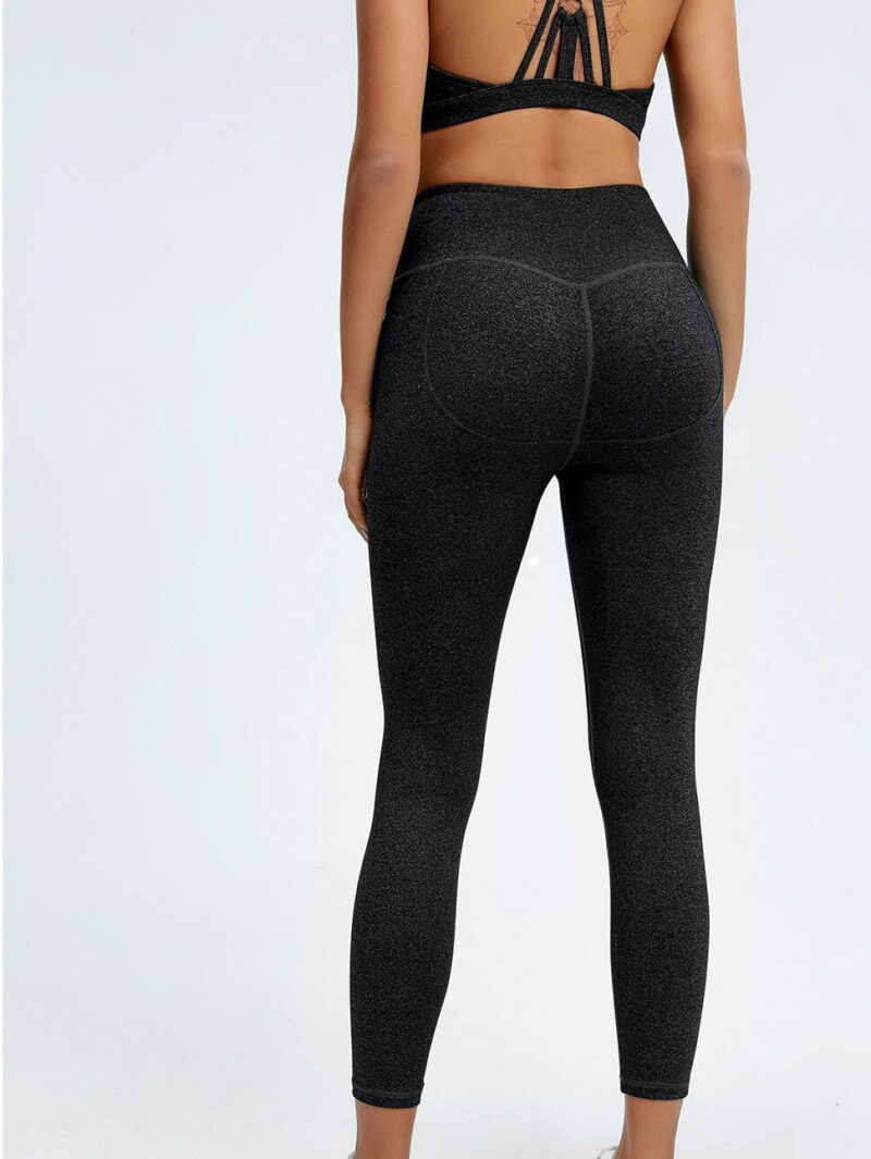 Sultry Caged Racerback Yoga Set with Criss-Cross Top and Push Up Leggings for a Flattering Look.