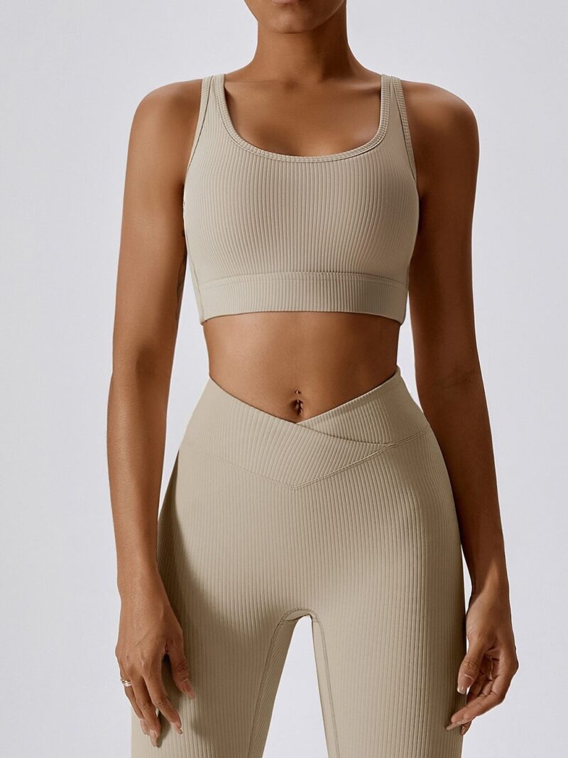 Indulge in Comfort and Style with this Sexy Ribbed Backless Strappy Sports Bra and Elastic V-Waist Leggings Set. Enjoy the Softness and Stretch of this Athletic Wear for a Perfect Fit.