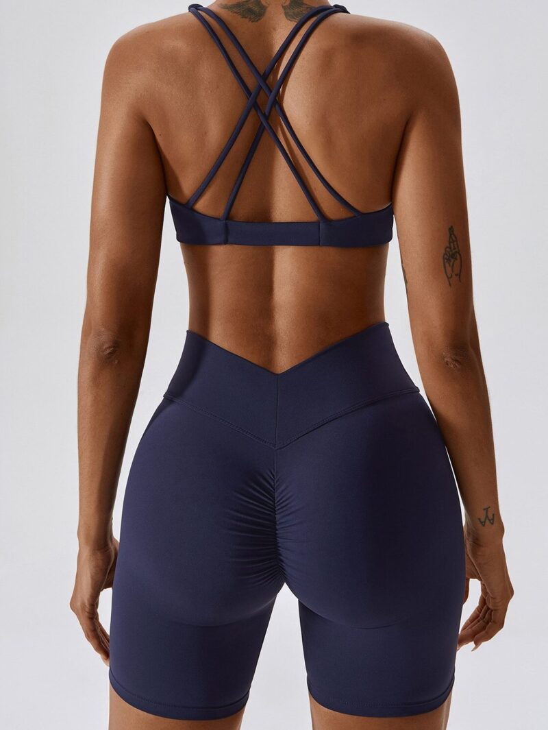 This stylish activewear set features a Criss-Cross Twist Front Sports Bra and V-Waist Scrunch Butt Shorts, perfect for any workout. Get ready to turn heads with this unique combination of comfort and style.