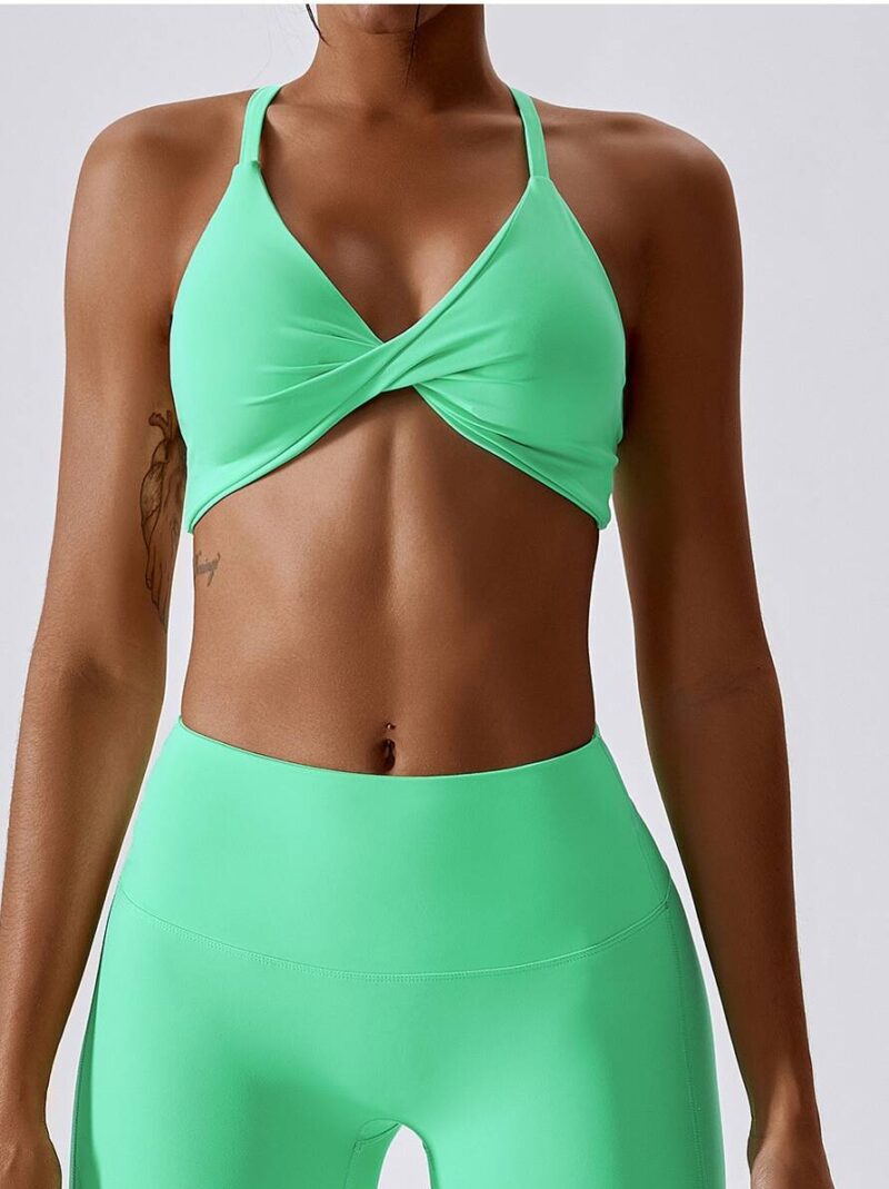 Move with Comfort and Style in this Halter Neck Sports Bra with Flattering Front Twist Detail!