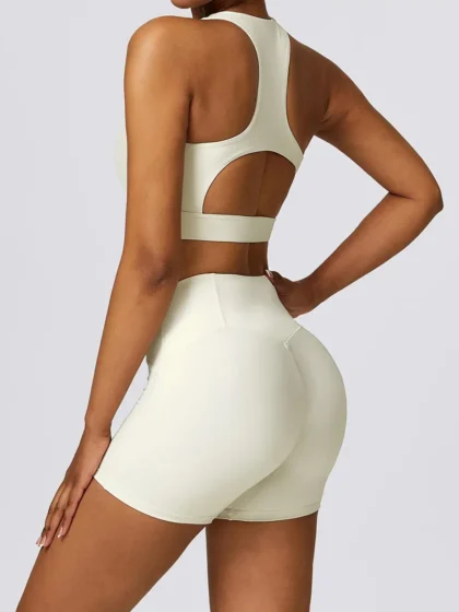 Look and Feel Sexy in Our Cut-Out Racerback Athletic Bra & High-Waist Elastic Athletic Shorts Set! Show Off Your Curves and Move with Comfort in this Stylish and Supportive Sports Outfit.